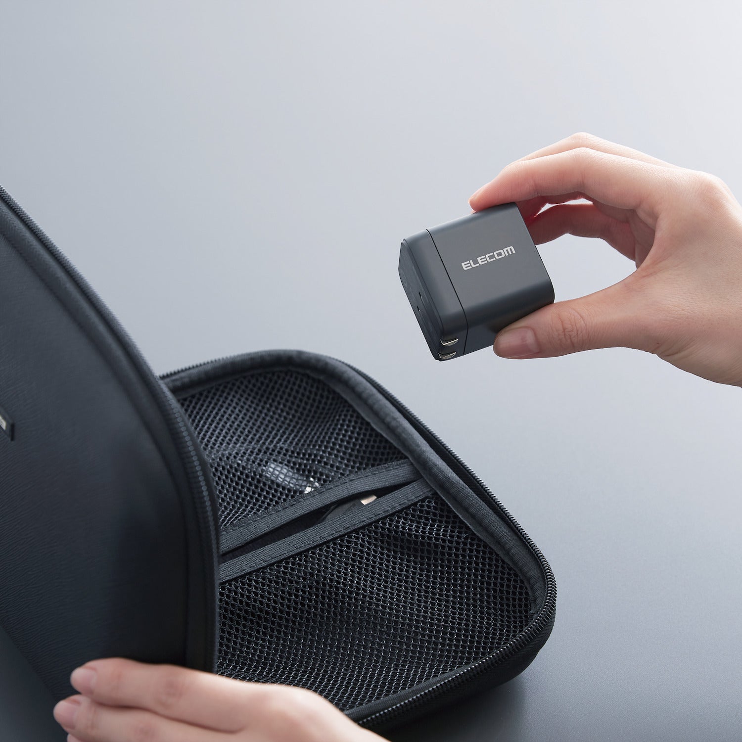Black Compact Charger GaNII 65W USB-C hand storing into small storage bag | Elecom ultra-high output device charger