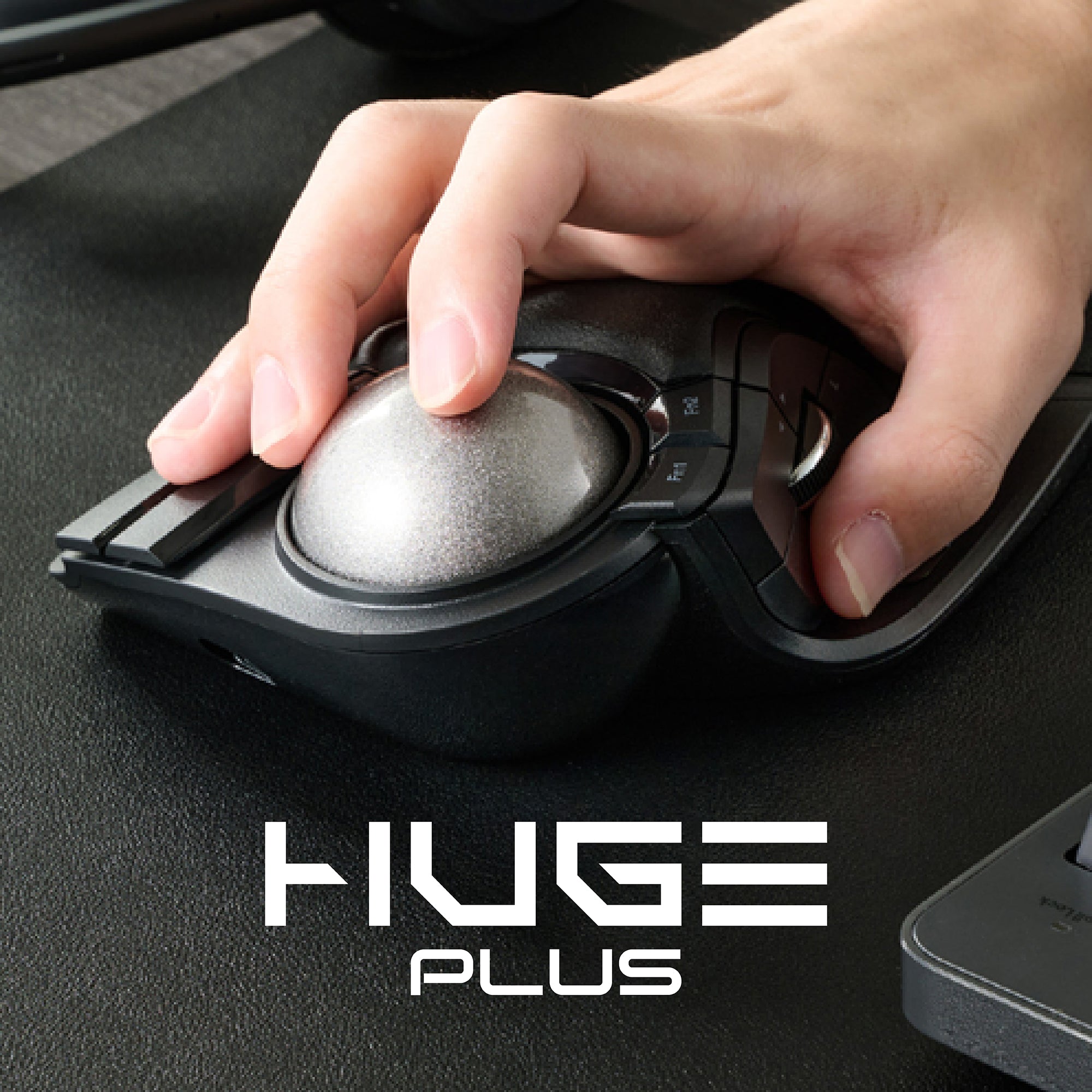 Hand scrolling large silver trackball on ergonomic mouse during work