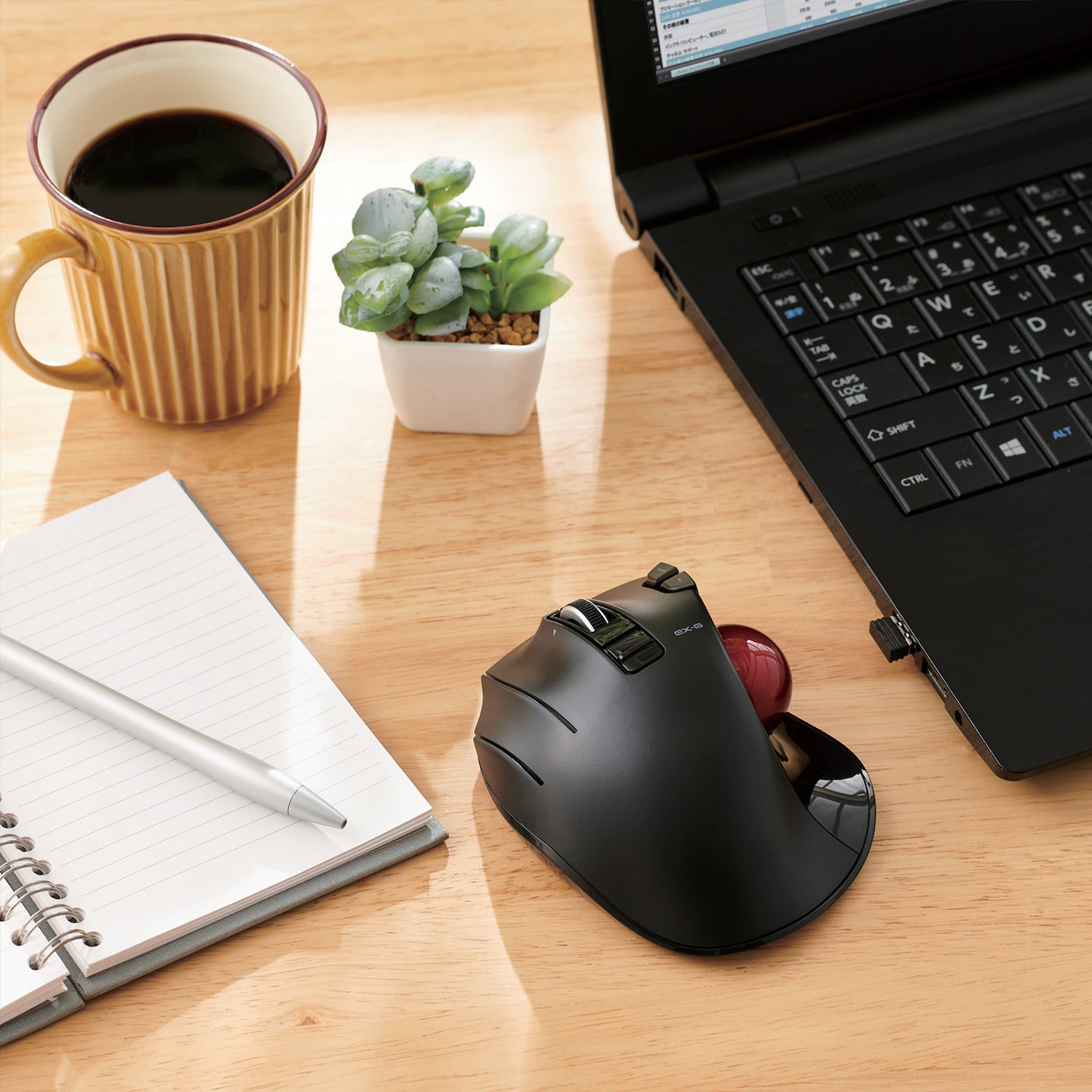 Wooden table with laptop left-handed trackball mouse, coffee, and notepad | Left-Handed Wireless Trackball Mouse