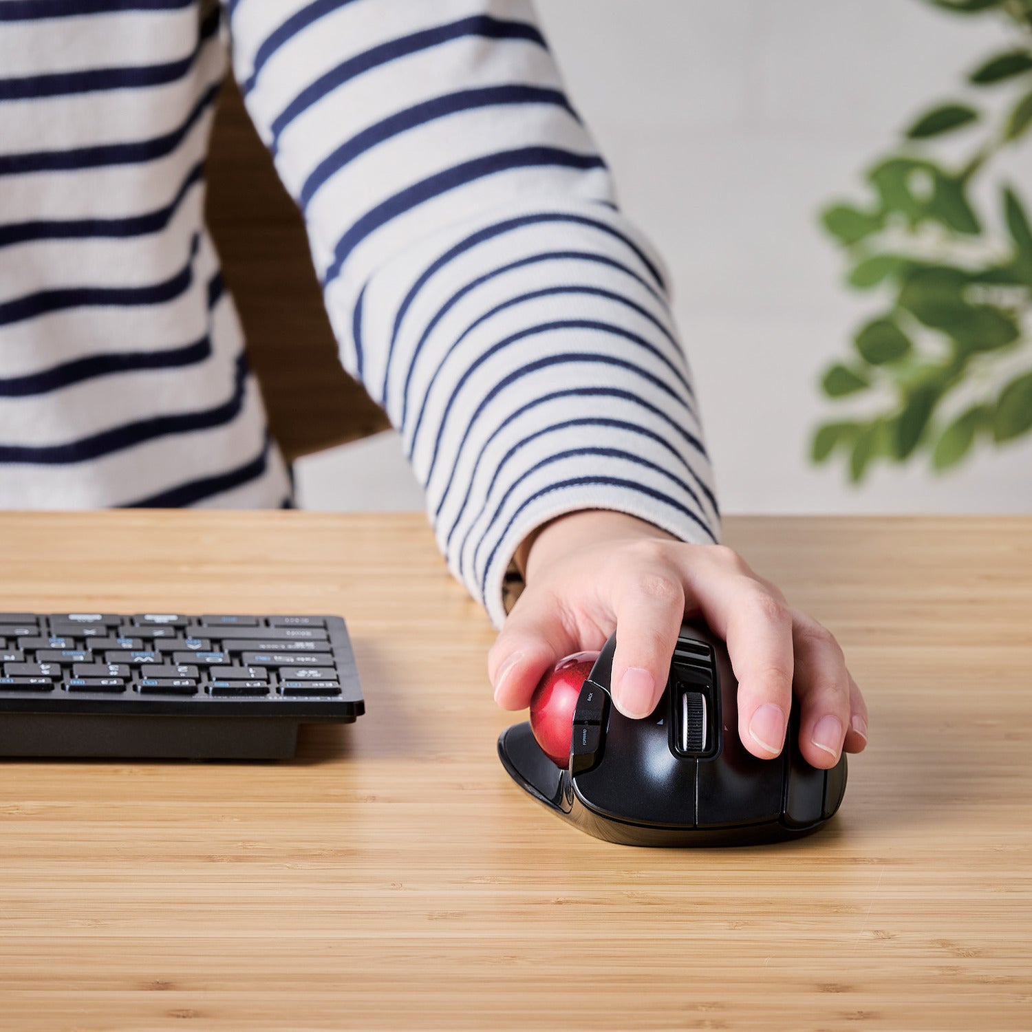 Left-handed person using trackball mouse and keyboard on a desk | Left-Handed Wireless Trackball Mouse