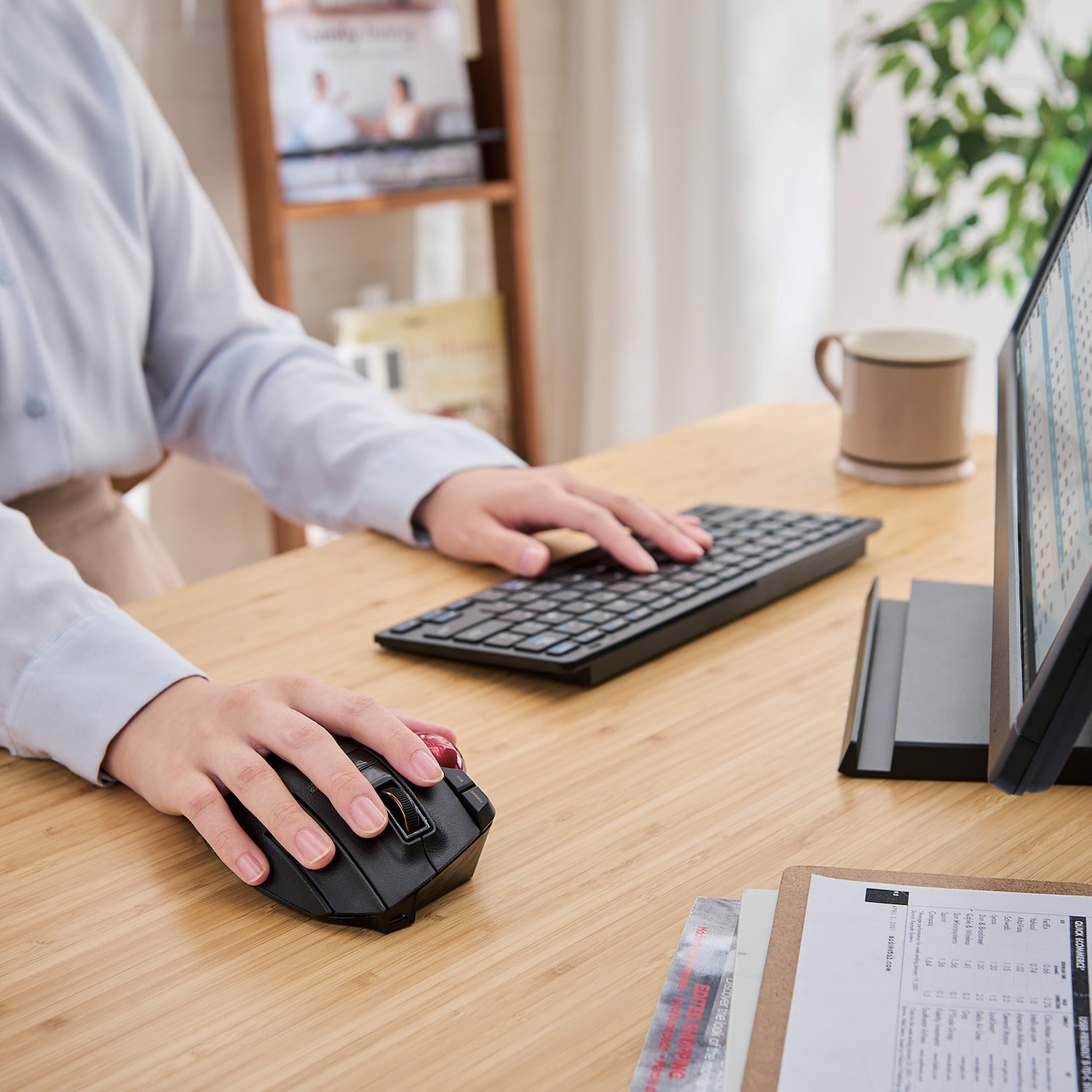 Using Black EX-G PRO Trackball Red Ball next to keyboard and monitor on a table | Elecom Wireless Trackball mouse