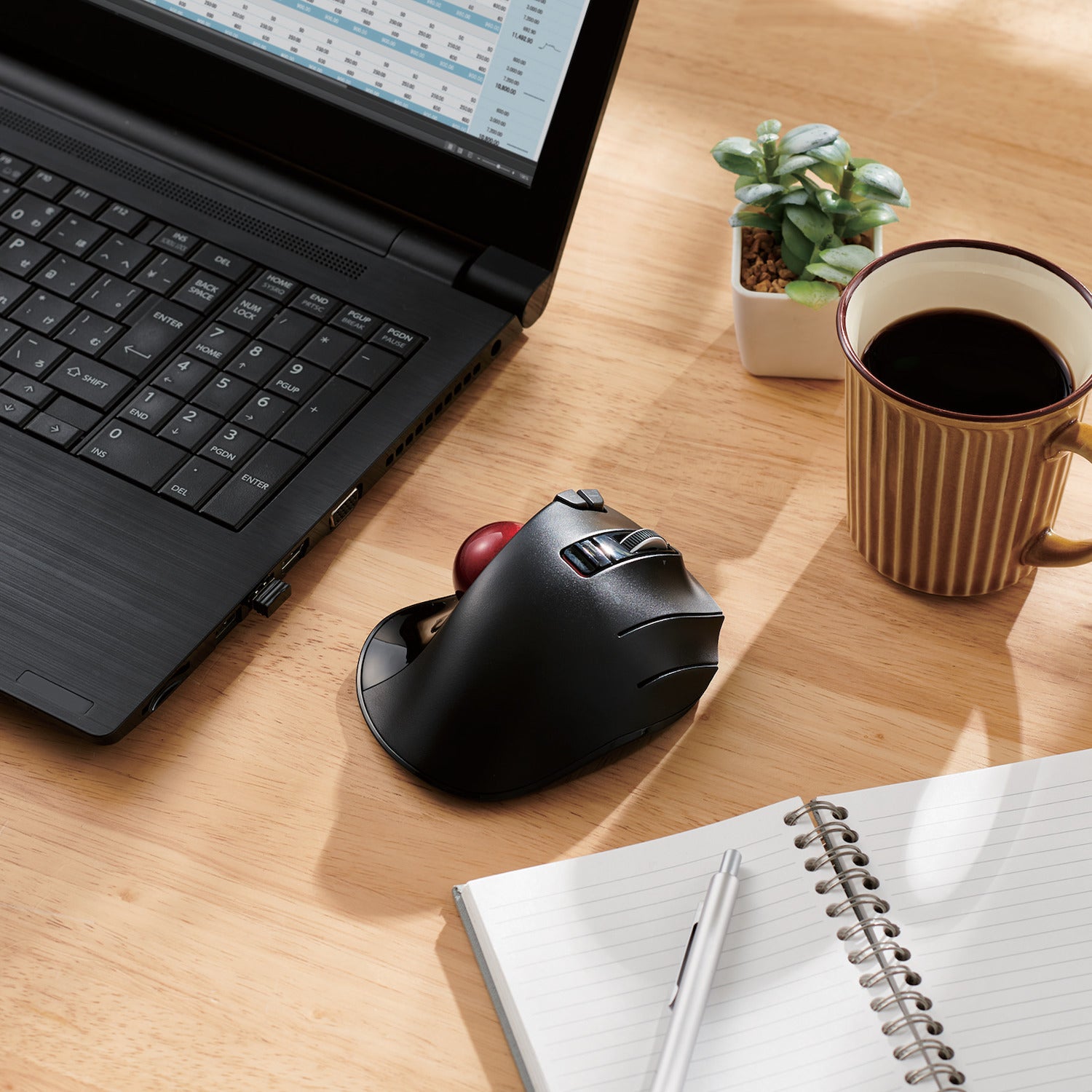 Black EX-G Trackball Wireless USB on a desk next to a black laptop notepad and cup of coffee | Wireless Trackball Mouse