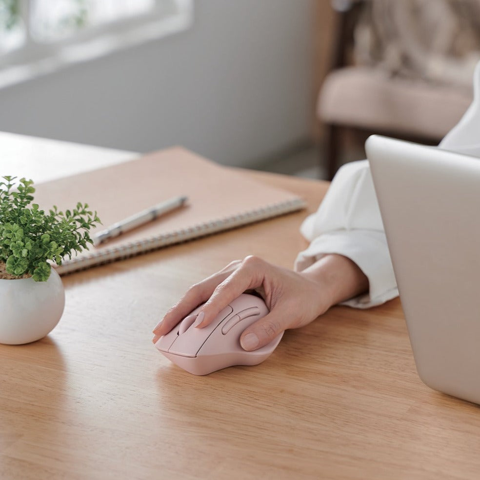 White SH30 Ergonomic Mouse Bluetooth hand using pink mouse next to a laptop spiral notebook pen on wooden desk | Elecom Ergonomic Bluetooth Mouse