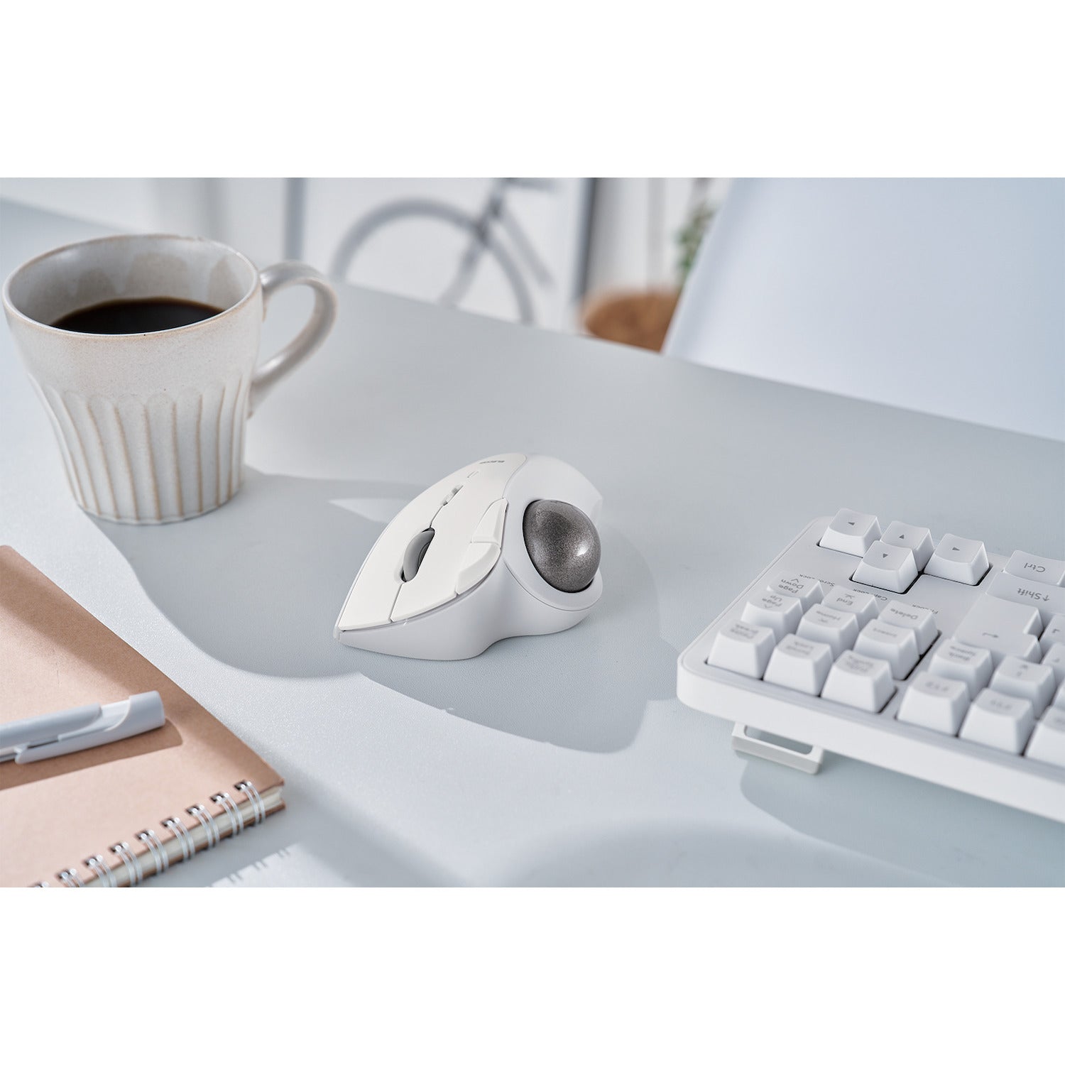 IST ergonomic trackball bluetooth connection lifestyle image with white coffee cup and white keyboard