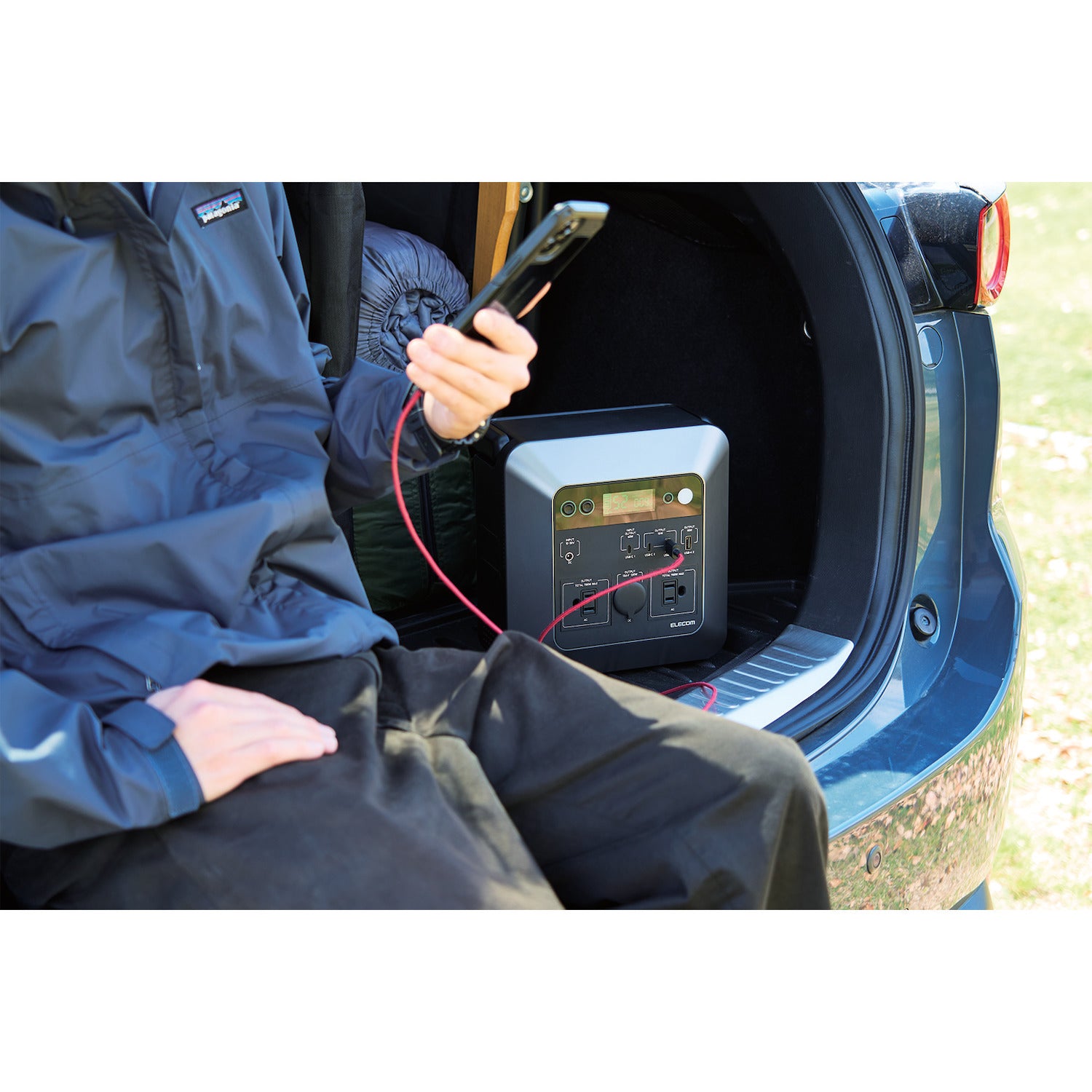 portable compact power station charging iphone while off roading